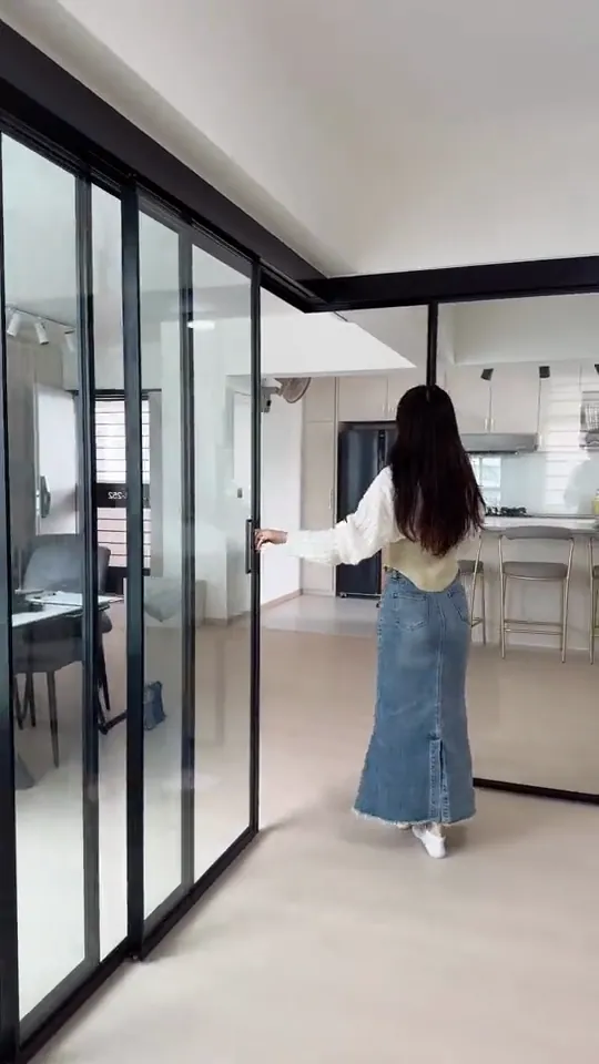 Video: four black-framed glass panels slide across a study enclosure, filmed from several angles